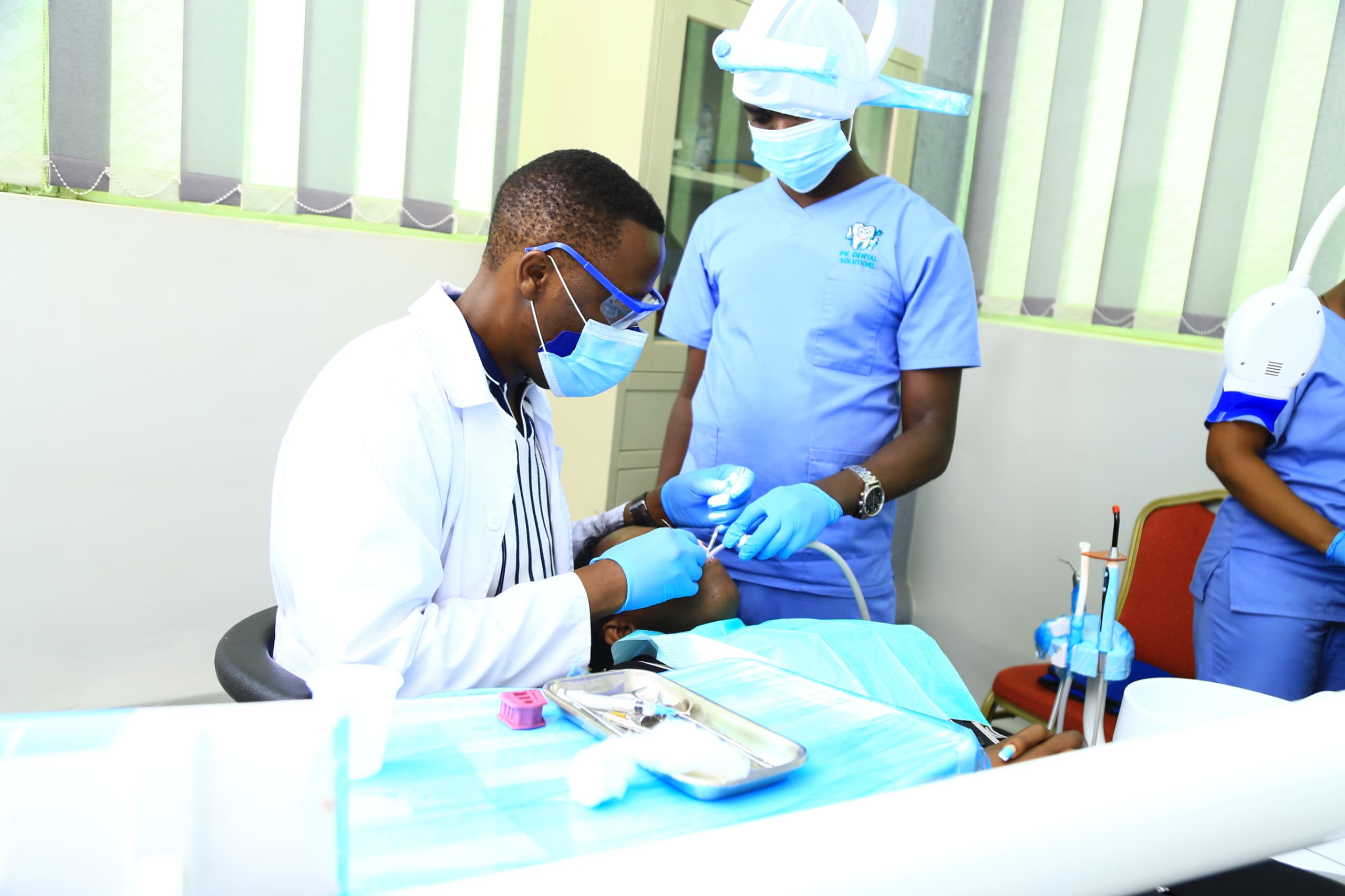 Dentist performing a dental procedure at PK Dental Solutions in Kampala