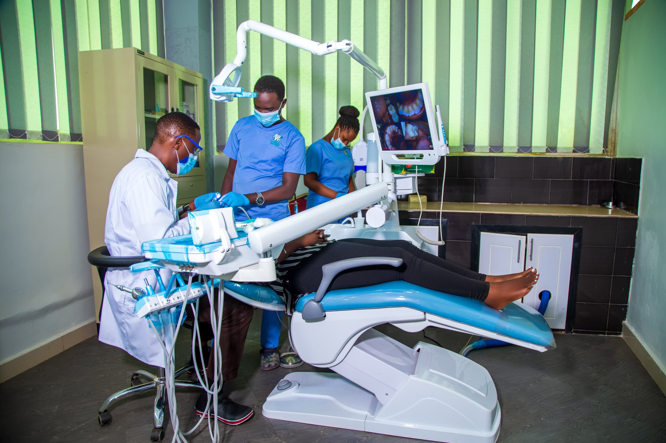 Dentist performing treatment at PK Dental Solutions in Kampala